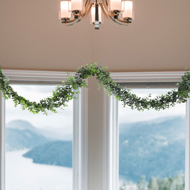 Norfolk Pine Christmas Garland wrapped around a staircase banister