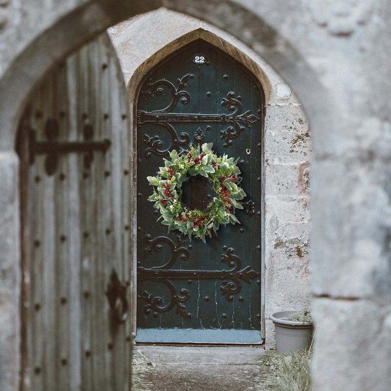 Farmhouse Artificial Berry Christmas Wreath hung on a wooden door