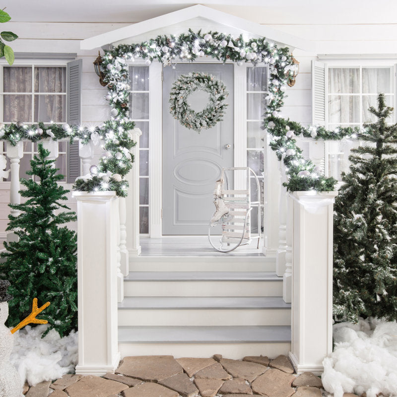 22" Farmhouse Artificial Pine Christmas Wreath hanging on a front door