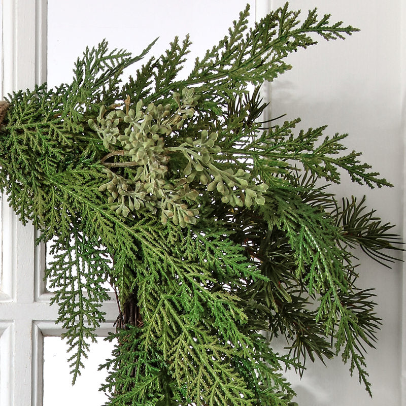 16" Artificial Poinsettia Christmas Wreath hung on a wooden door