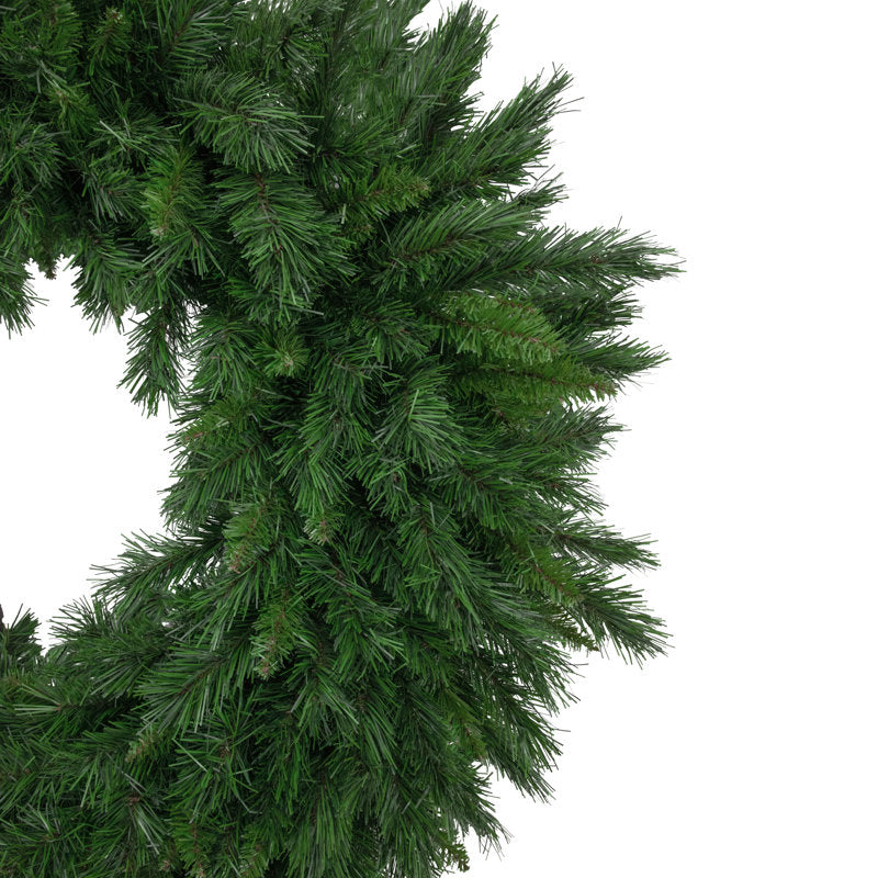 22" Artificial Christmas Wreath hung on a wooden door