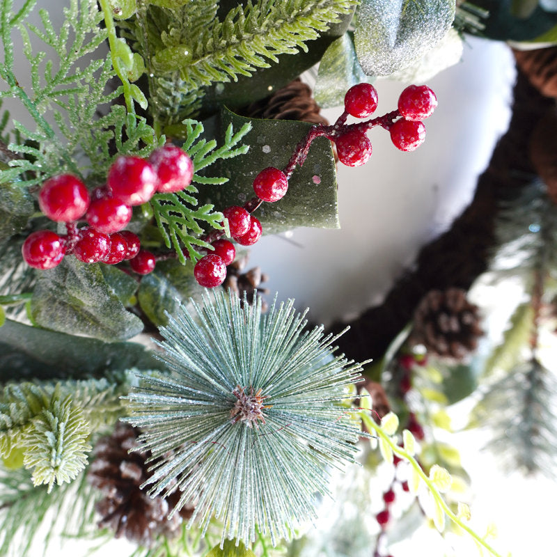 Pre-Lit Artificial Christmas Wreath hung on a wooden door