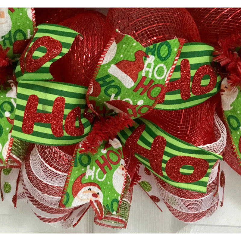 24" Pre-Lit Artificial Christmas Wreath displayed on a front door