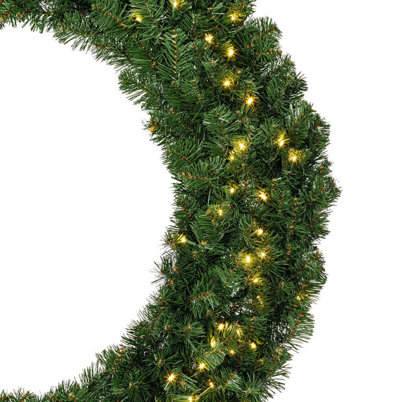 24" Pre-Lit Artificial Pine Christmas Wreath hung on a wooden door