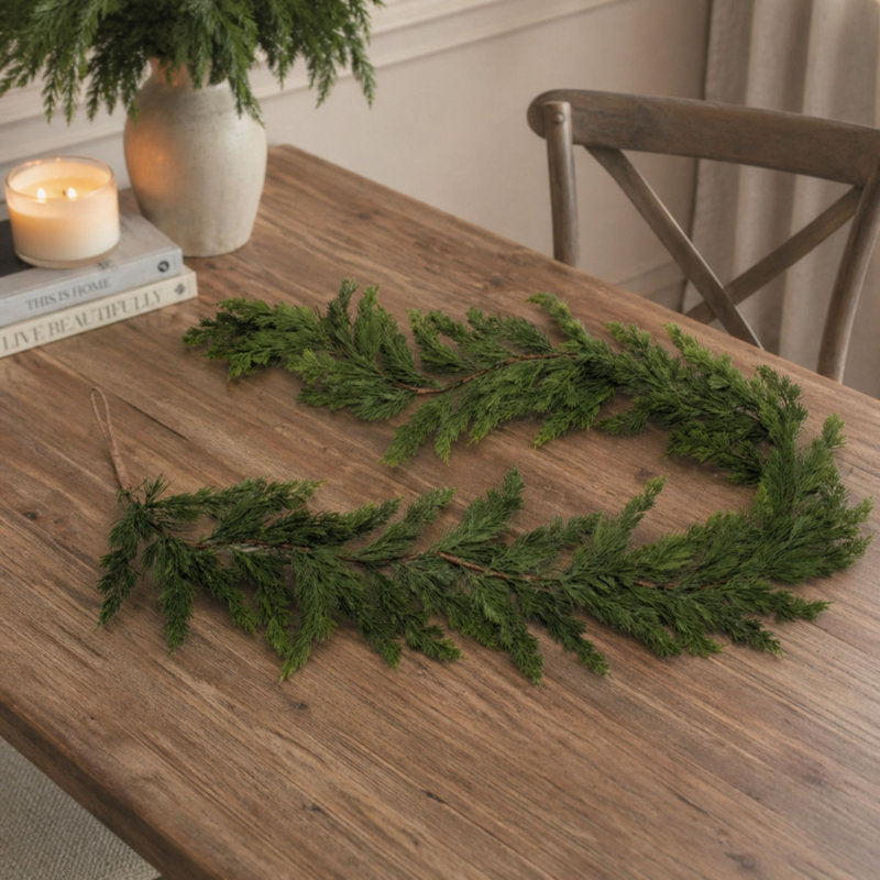 9 ft Pre-Lit Artificial Pine Christmas Garland wrapped around a staircase banister