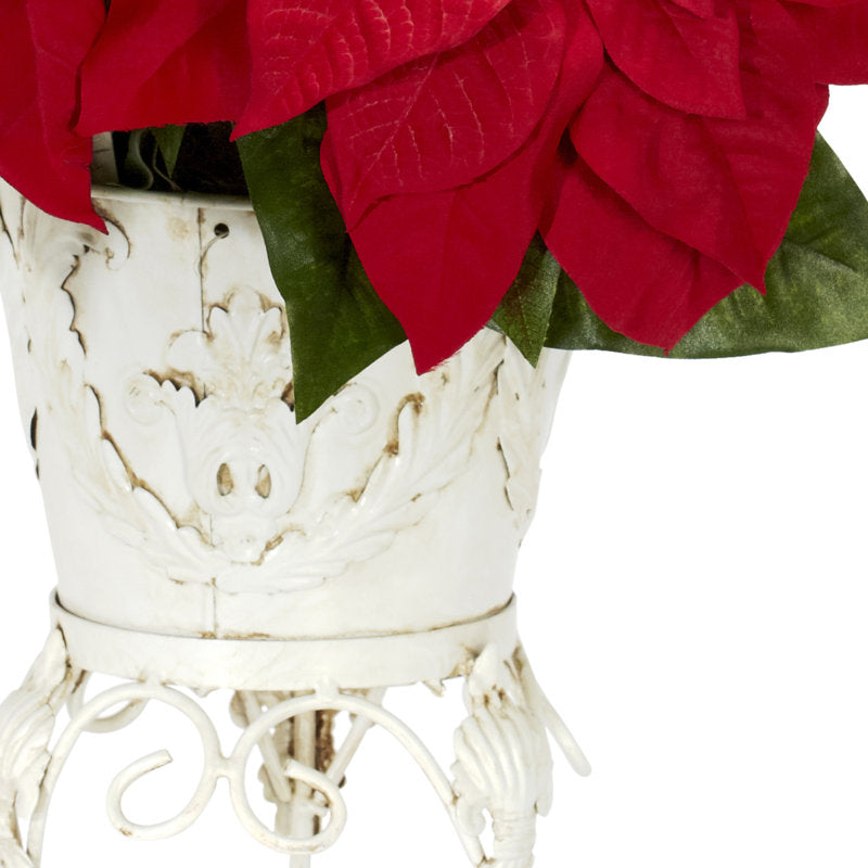 Artificial poinsettia arrangement in a planter