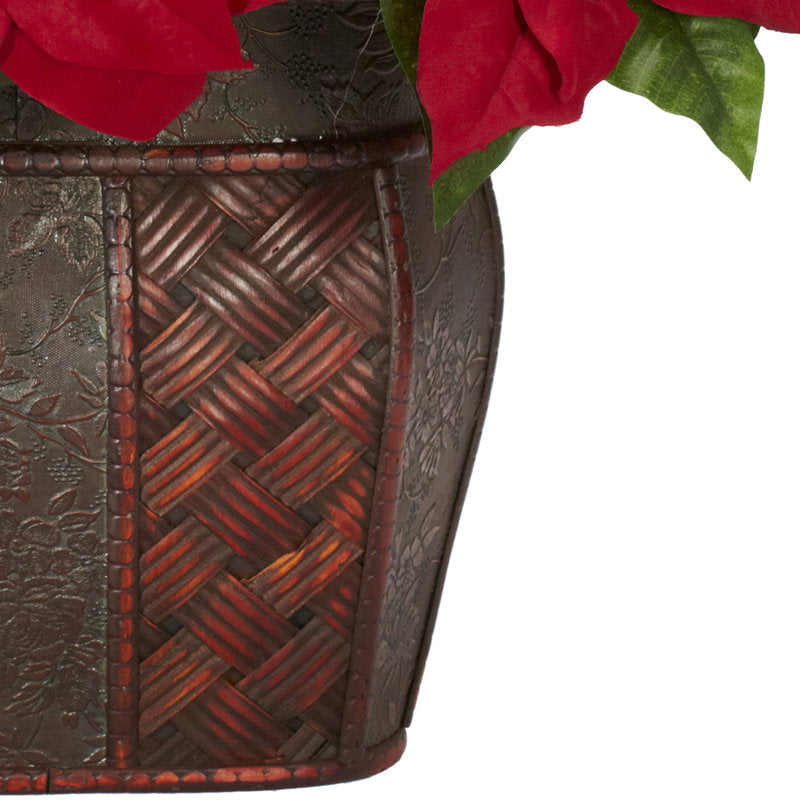 Artificial poinsettia arrangement in a vase