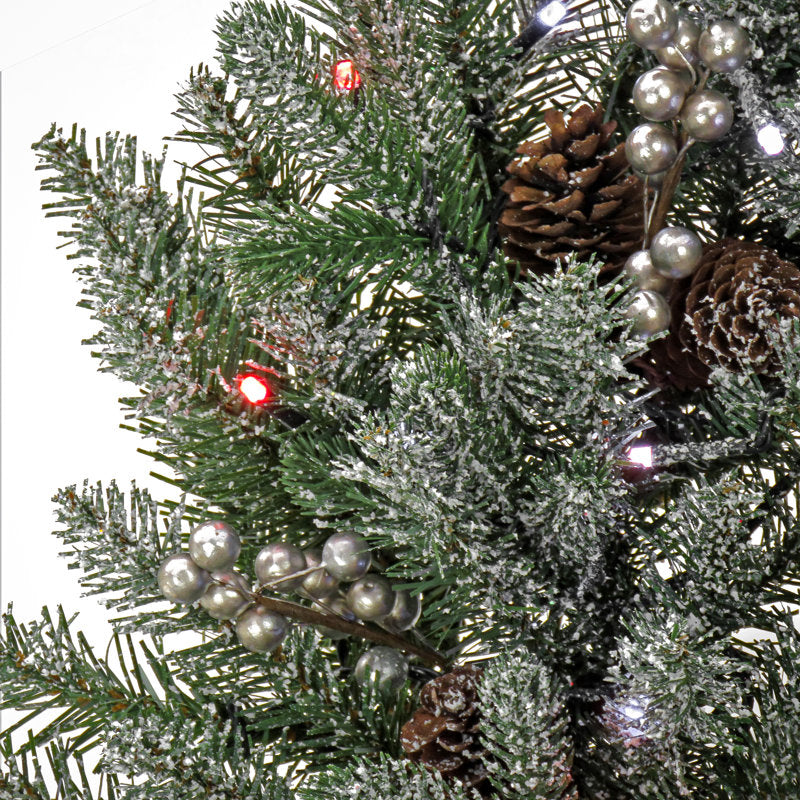 24" Farmhouse Artificial Pine Christmas Wreath hung on a wooden door