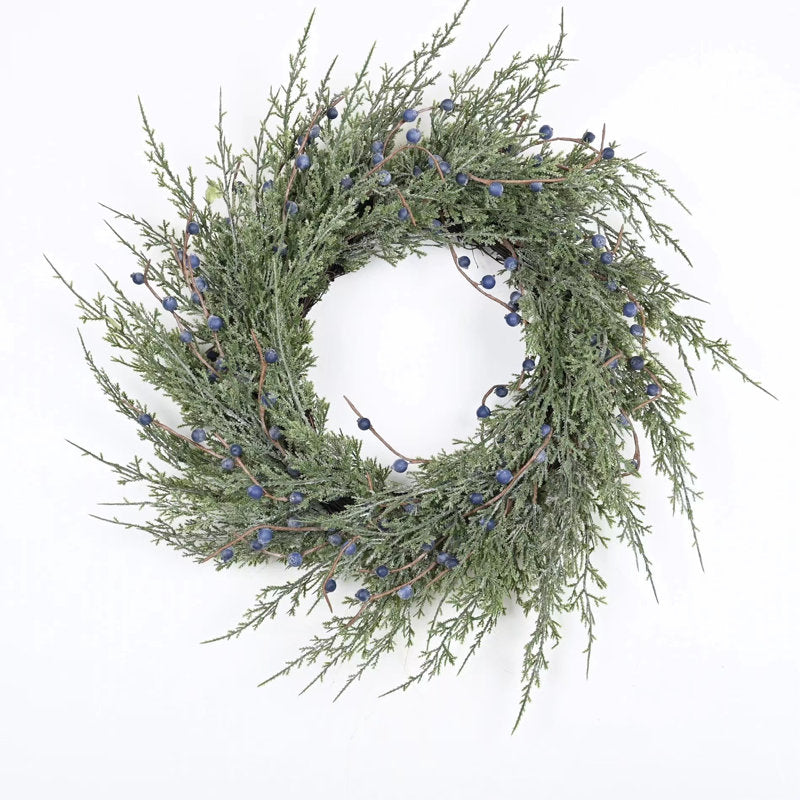 24" Artificial Cypress Christmas Wreath hung on a wooden door