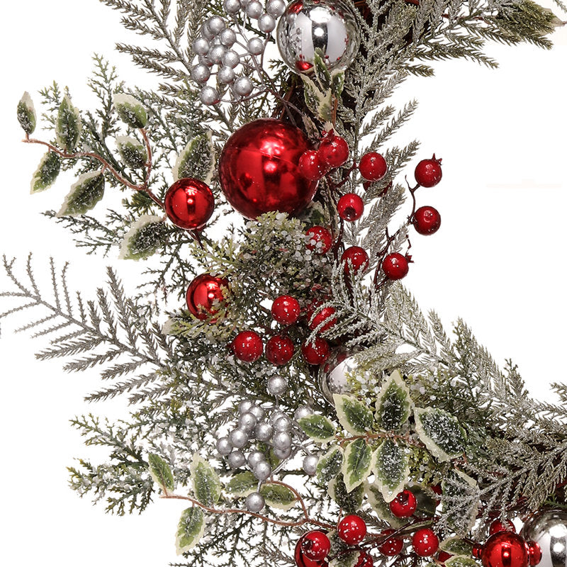 4" Artificial Spruce Christmas Wreath displayed on a front door