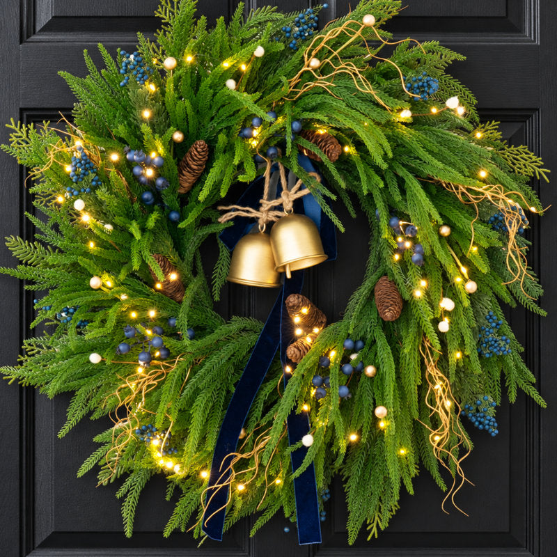 24" pre-lit blue Norfolk Pine Christmas wreath with LED lights and berries