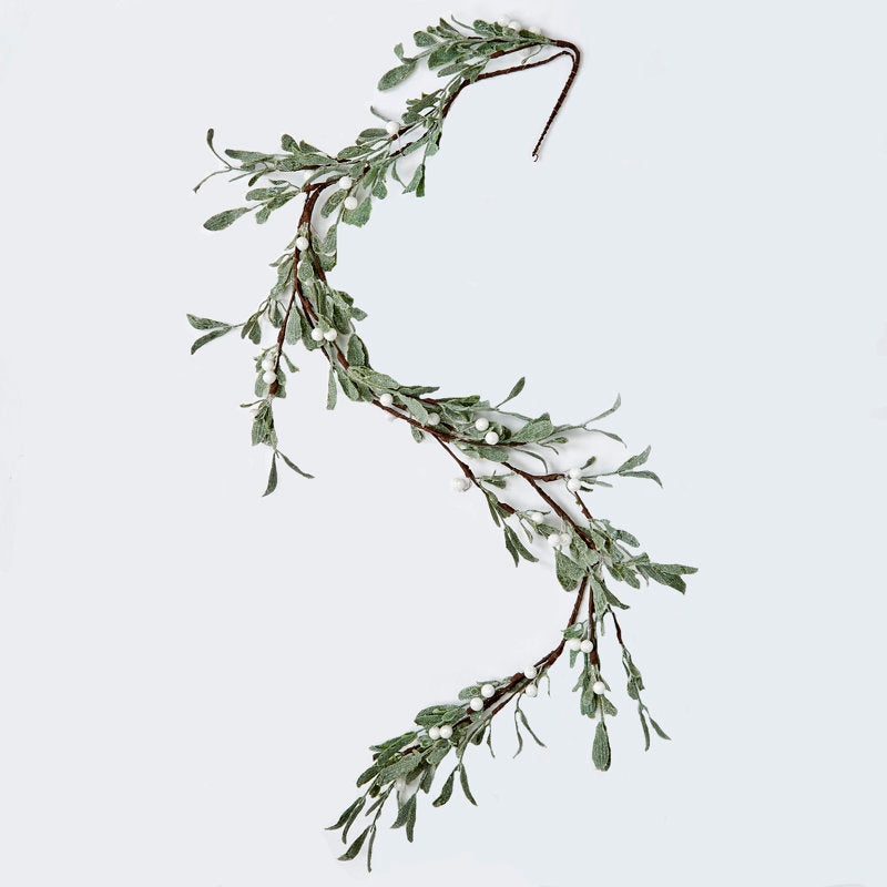 Rustic Bell Christmas Garland wrapped around a staircase banister