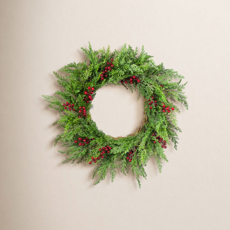 24" Artificial Cedar Christmas Wreath displayed on a front door