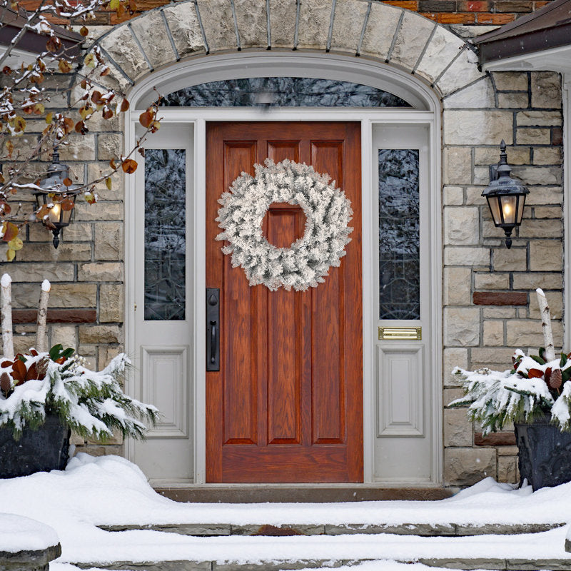 28" Artificial Berry Christmas Wreath hanging on a front door
