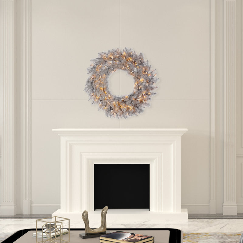 24" Pre-Lit Artificial Pine Christmas Wreath displayed on a front door