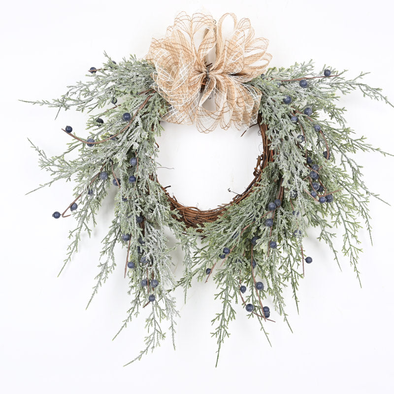 Cypress Christmas wreath with berries and a bow