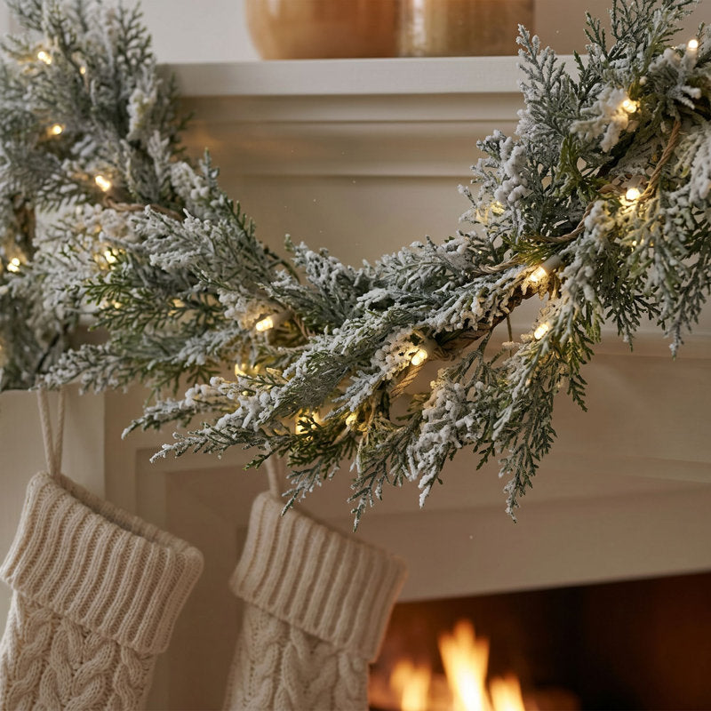24" Pre-Lit Christmas Garland wrapped around a staircase banister