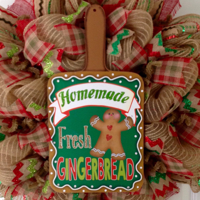 24" Artificial Christmas Wreath displayed on a front door
