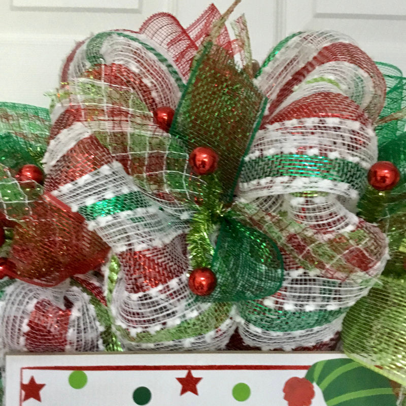 20" Pre-Lit Artificial Pine Christmas Wreath hung on a wooden door