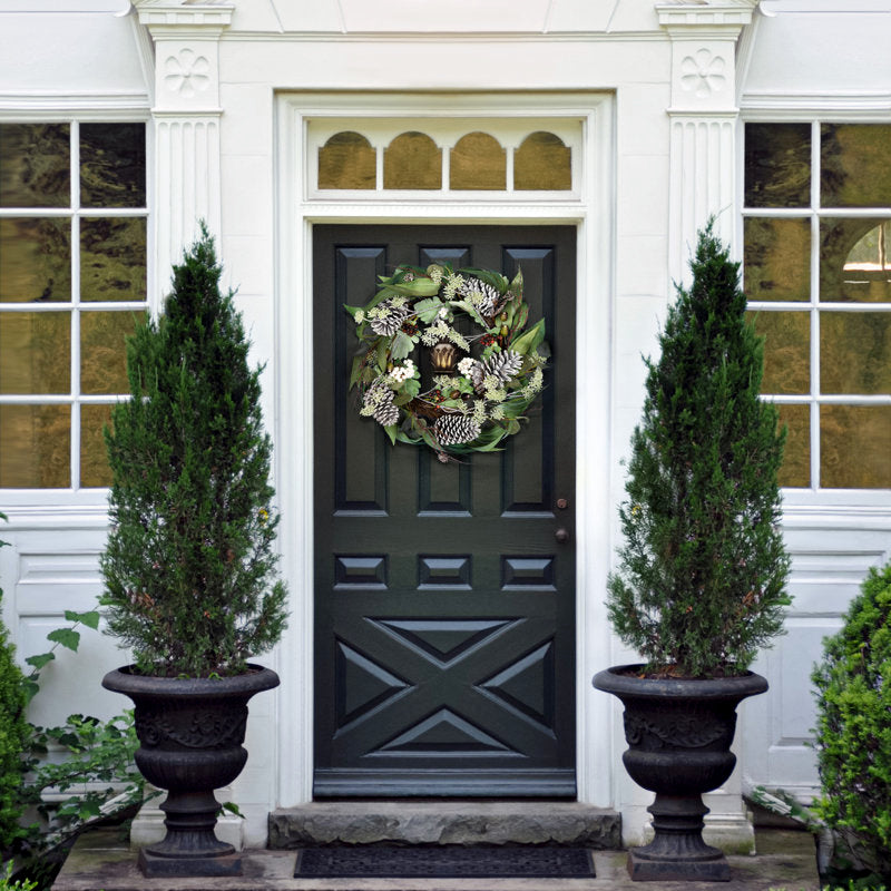 24" Artificial Berry Christmas Wreath displayed on a front door