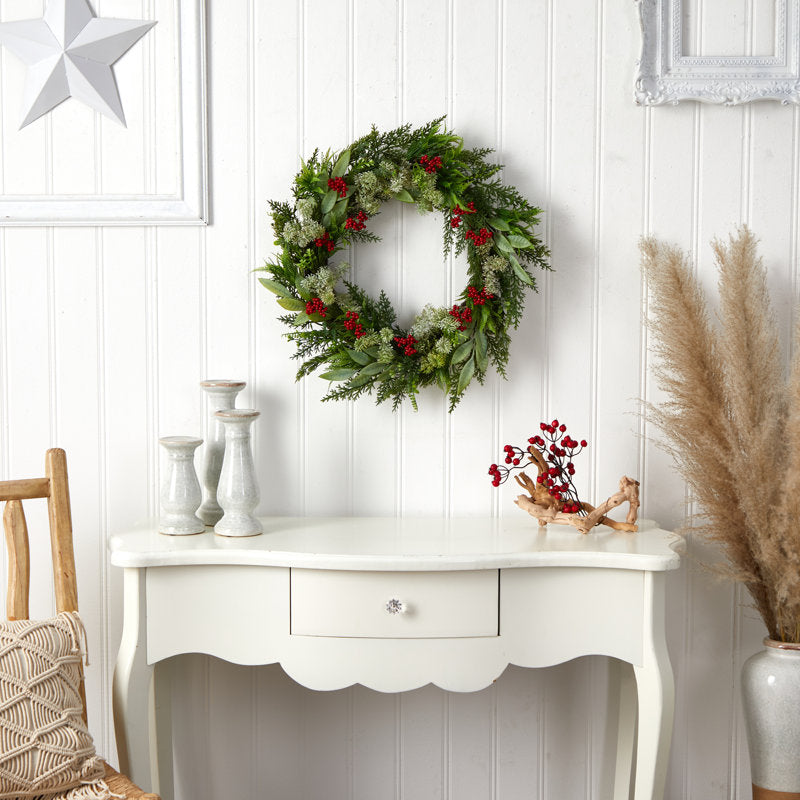 24" Pre-Lit Frosted Pine Christmas Wreath hung on a wooden door