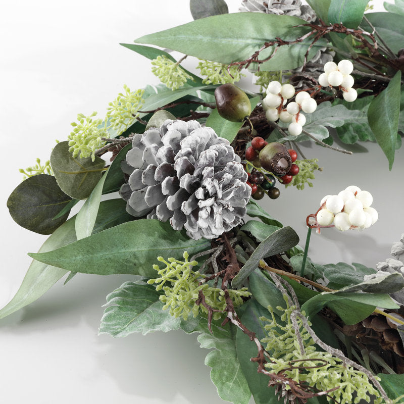 24" Artificial Berry Christmas Wreath displayed on a front door