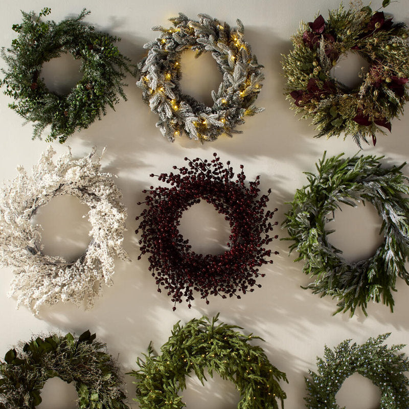 Pre-Lit Flocked Artificial Fir Christmas Wreath displayed on a front door