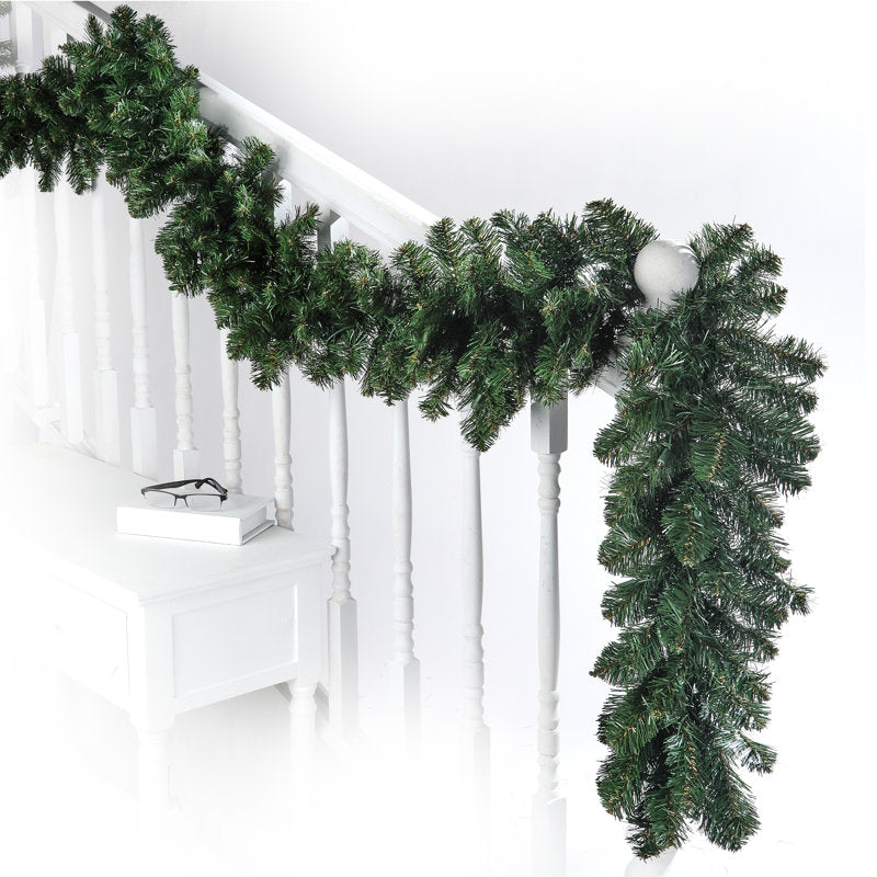 9 ft Pre-Lit Artificial Christmas Garland wrapped around a staircase banister