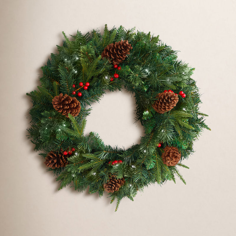24" Pre-Lit Artificial Pine Christmas Wreath hung on a wooden door