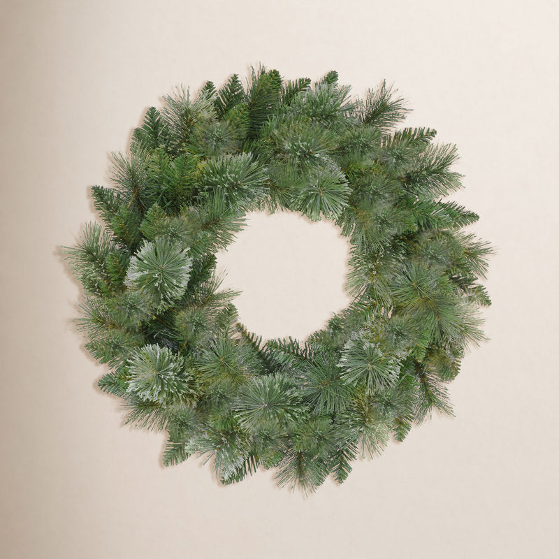 24" Pre-Lit Artificial Pine Christmas Wreath hung on a wooden door