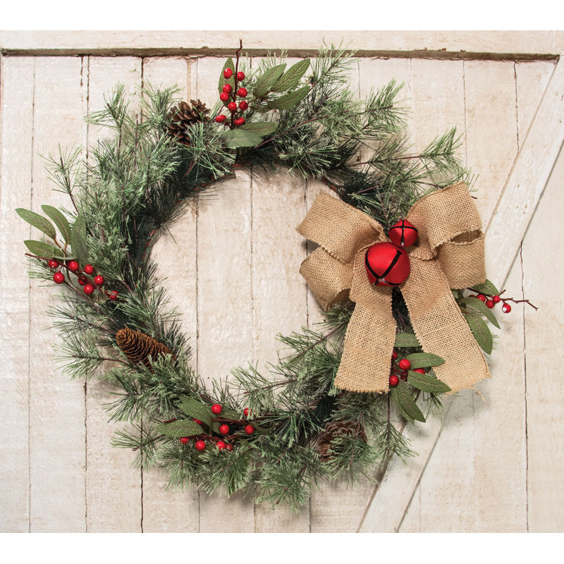 24" Artificial Pine Christmas Wreath hanging on a front door