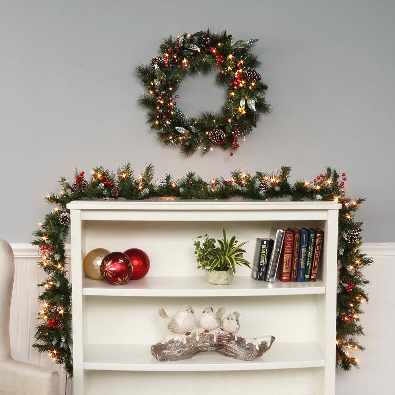 Pre-Lit Frosted Artificial Berry Christmas Wreath hung on a wooden door