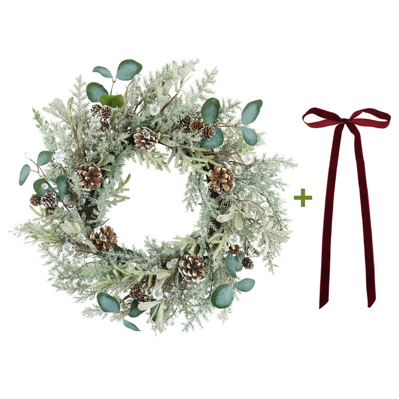 Frosted cedar Christmas wreath with pinecones and a velvet bow