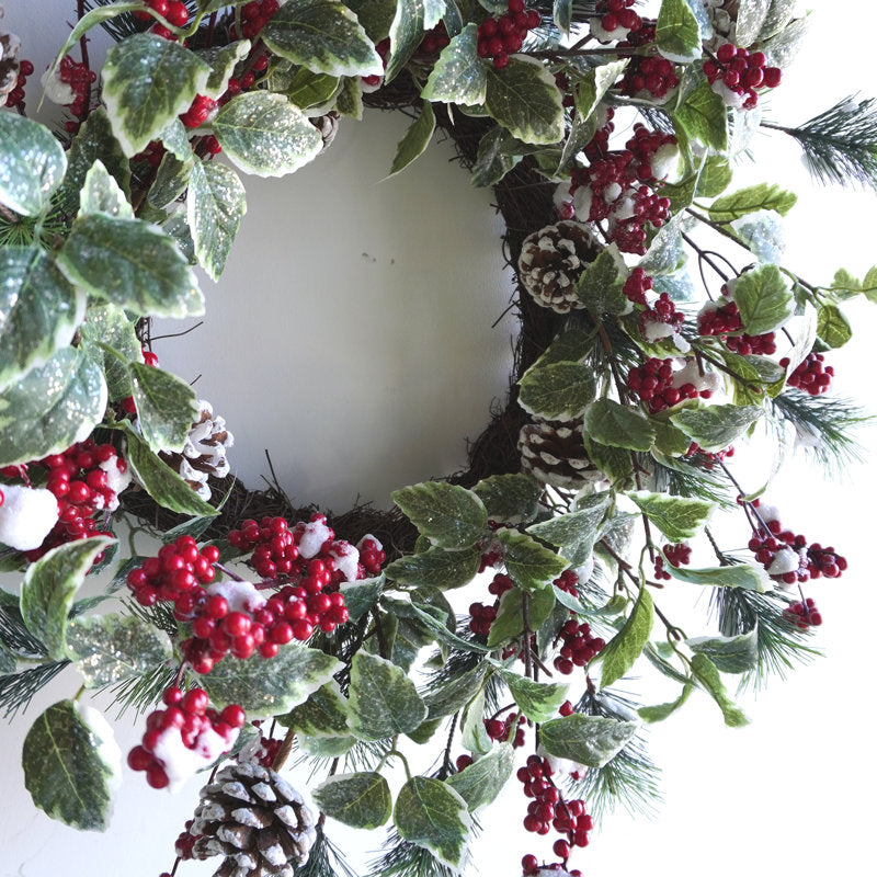 24" Pre-Lit Artificial Spruce Christmas Wreath hanging on a front door