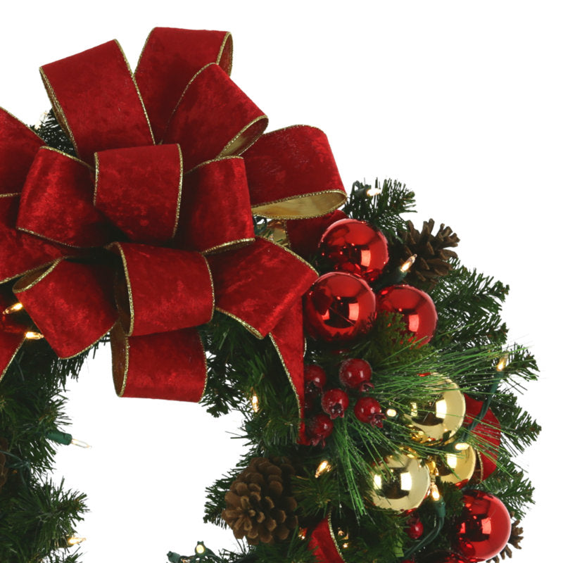 24" Artificial Eucalyptus Christmas Wreath hung on a wooden door