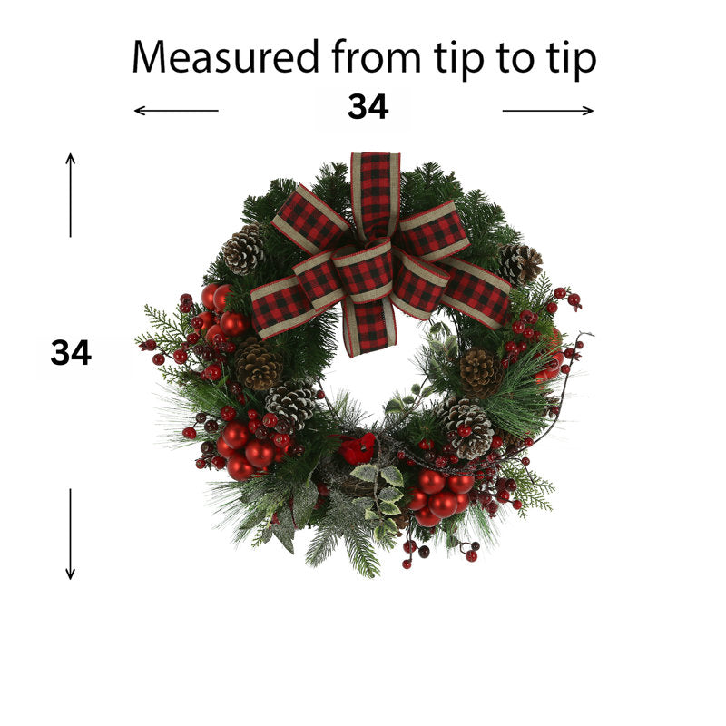 24" Artificial Cedar Christmas Wreath hung on a wooden door