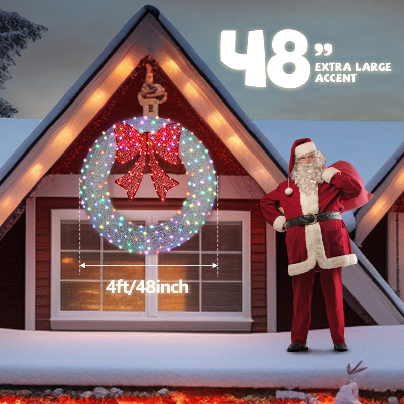 24" Pre-Lit Artificial Christmas Wreath displayed on a front door