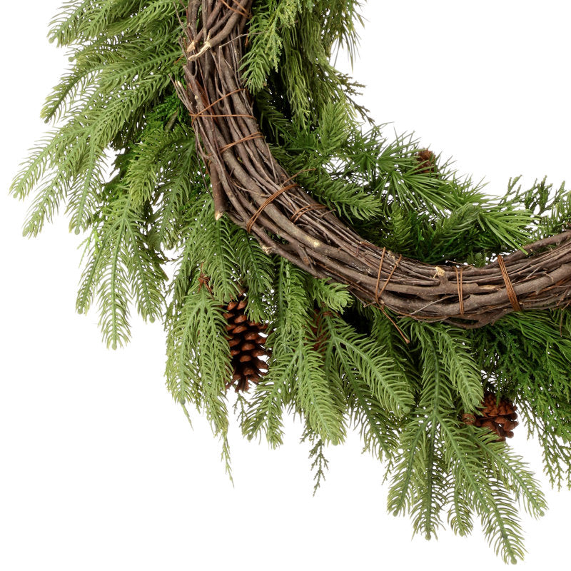 Flocked Artificial Pine Christmas Wreath hung on a wooden door