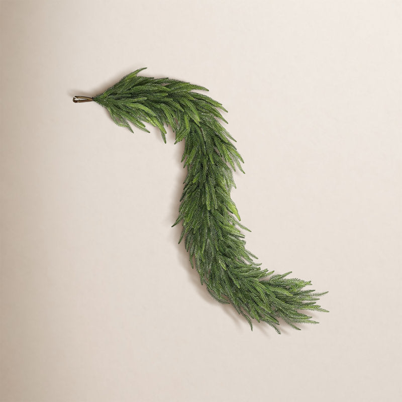 4 ft Glittered Pine Christmas Garland wrapped around a staircase banister