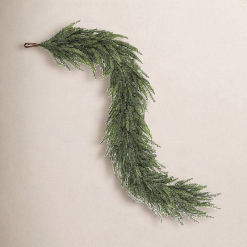 4 ft Glittered Pine Christmas Garland wrapped around a staircase banister