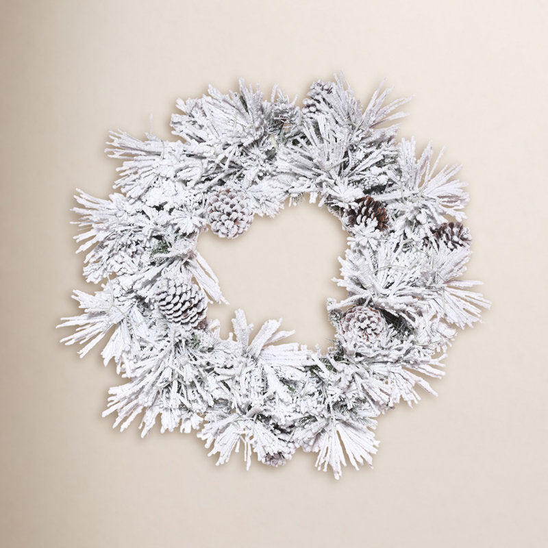 Flocked Artificial Christmas Wreath hanging on a front door
