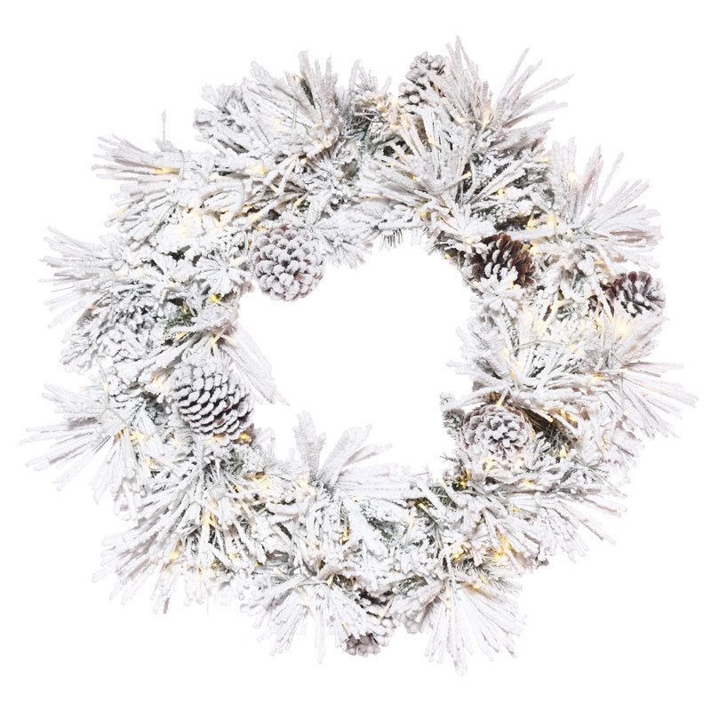 Flocked Artificial Christmas Wreath hanging on a front door