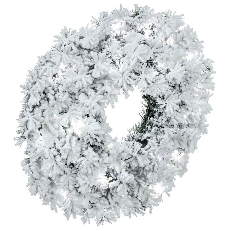 Flocked Artificial Christmas Wreath hung on a wooden door