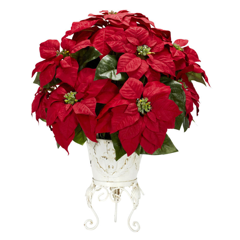 Artificial poinsettia arrangement in a planter