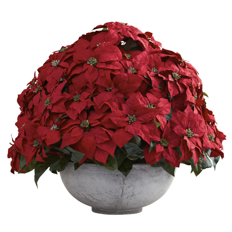 Artificial poinsettia arrangement in a planter