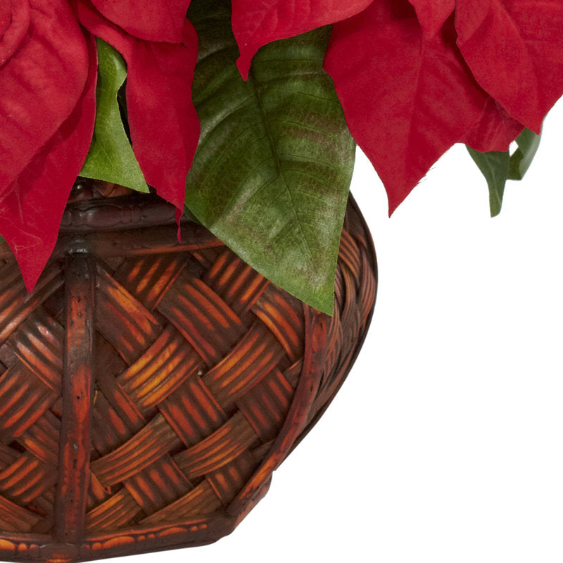 Artificial poinsettia arrangement in a planter