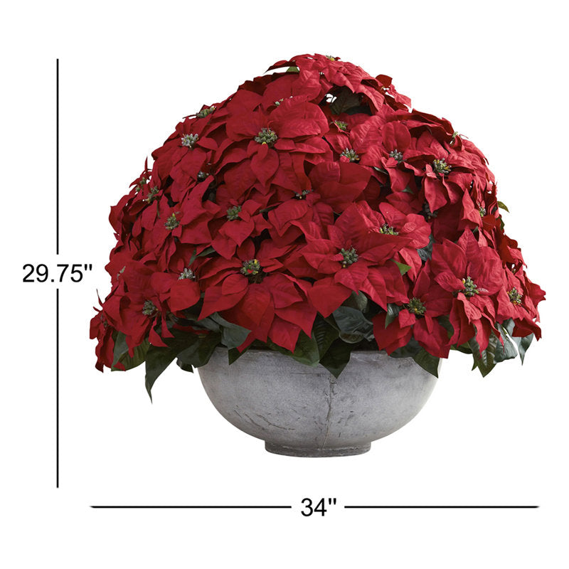 Artificial poinsettia arrangement in a planter