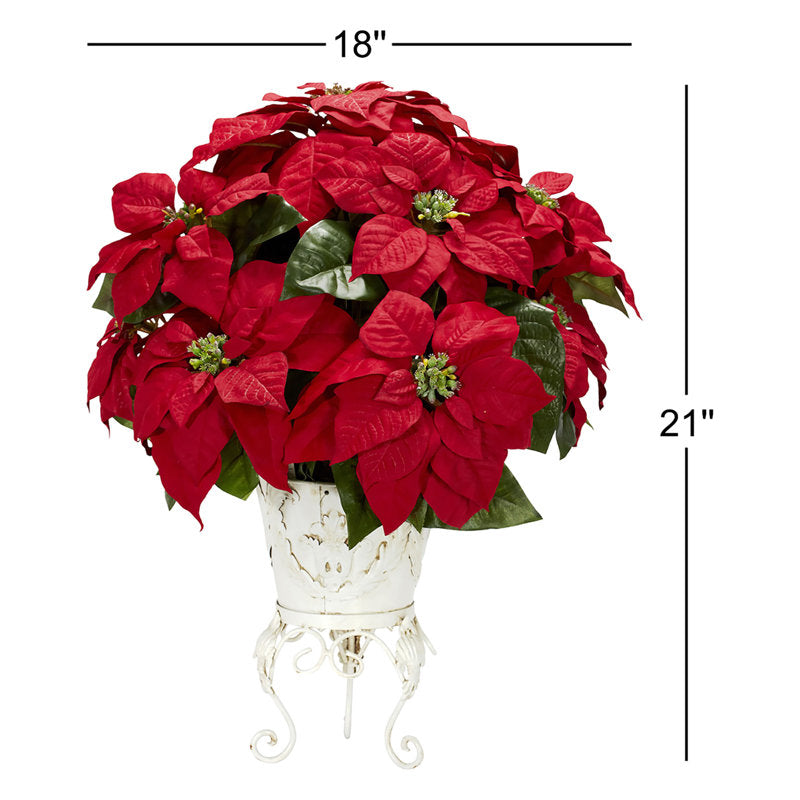 Artificial poinsettia arrangement in a planter