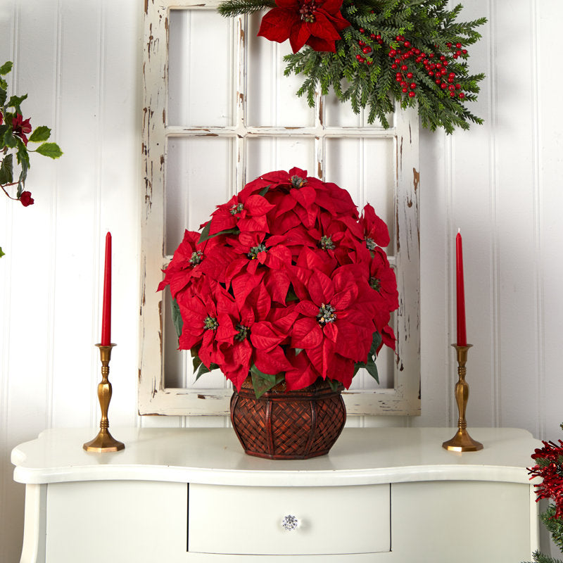 Artificial poinsettia arrangement in a planter