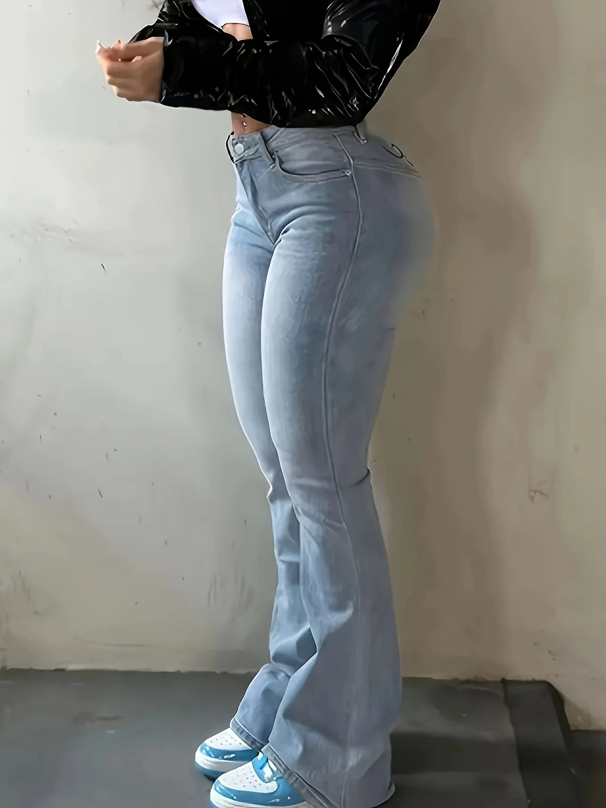 Light Blue High-Waisted Flared Jeans with Patterned Detailing on the Back Waistband